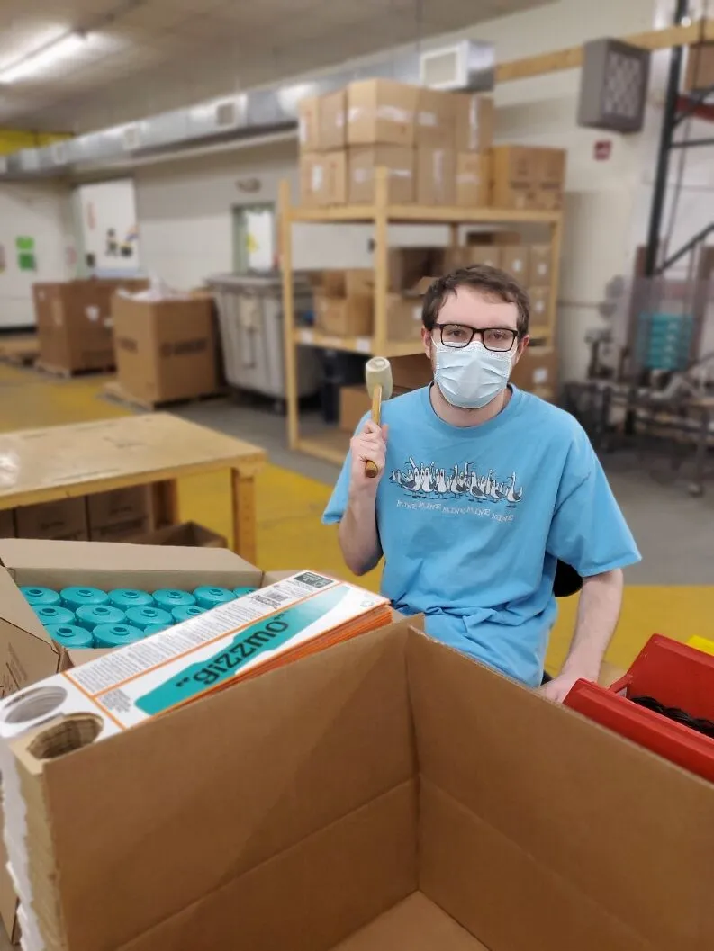 A Creekside Industries team member inspecting a packaged product