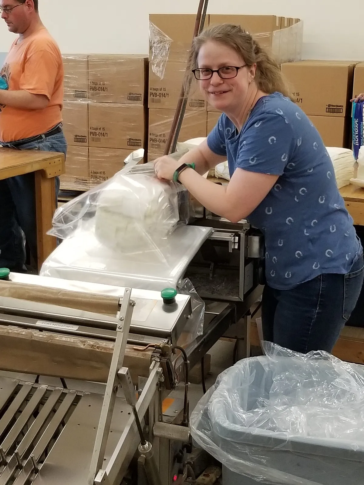 A Creekside Industries team member sealing a package on the fulfillment line